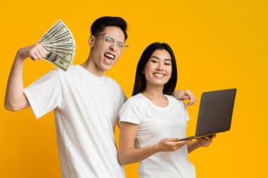 DollarSprout Rewards Review, Asian Couple Holding Laptop And Cash